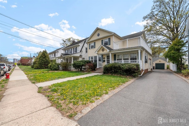 286 Easton Ave, New Brunswick, NJ 08901 - view of front of home with covered porch, a front yard, a detached garage, and asphalt driveway