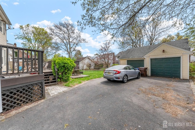 286 Easton Ave, New Brunswick, NJ 08901 - view of side of property with a wooden deck, a garage, and driveway