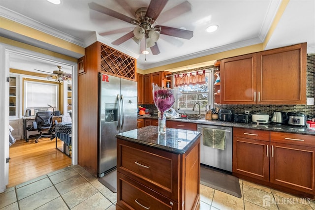 286 Easton Ave, New Brunswick, NJ 08901 - kitchen with appliances with stainless steel finishes, ceiling fan, crown molding, decorative backsplash, and a kitchen island