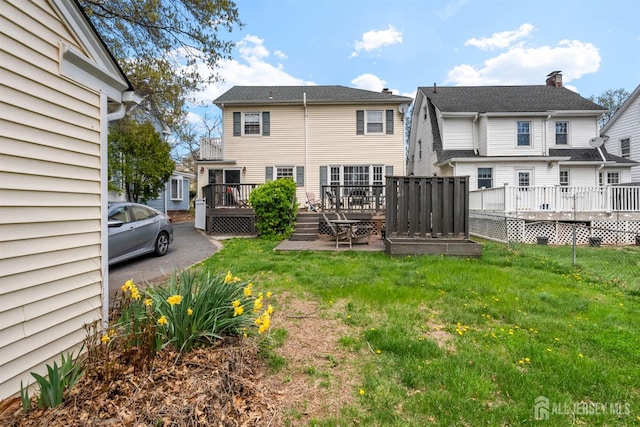 286 Easton Ave, New Brunswick, NJ 08901 - back of house featuring a wooden deck and a lawn