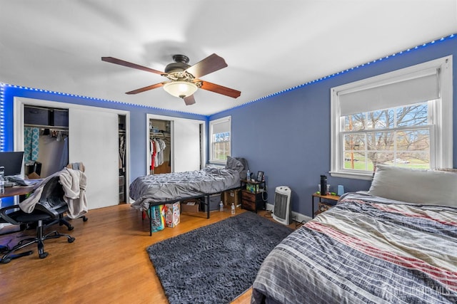 286 Easton Ave, New Brunswick, NJ 08901 - bedroom featuring wood finished floors, an office area, two closets, and ceiling fan