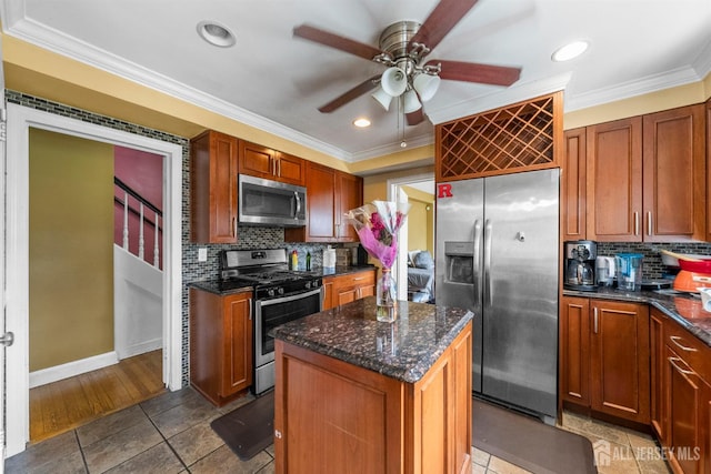 286 Easton Ave, New Brunswick, NJ 08901 - kitchen with stainless steel appliances, ceiling fan, backsplash, crown molding, and a center island