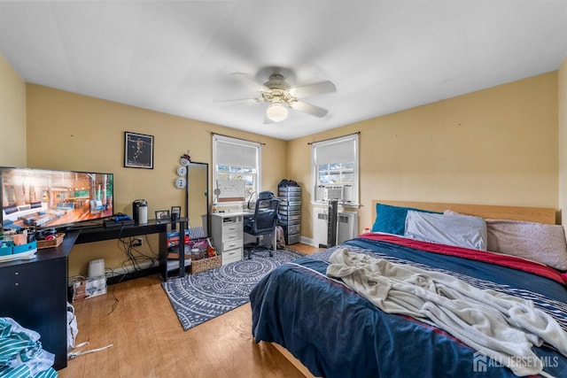 286 Easton Ave, New Brunswick, NJ 08901 - bedroom featuring wood finished floors, an office area, radiator heating unit, a ceiling fan, and cooling unit