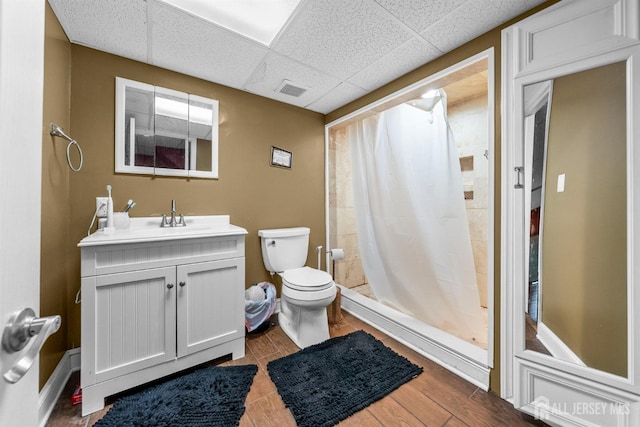 286 Easton Ave, New Brunswick, NJ 08901 - full bath with toilet, vanity, a tile shower, a drop ceiling, and wood finished floors