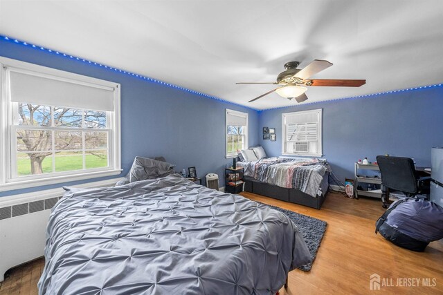 286 Easton Ave, New Brunswick, NJ 08901 - bedroom with radiator heating unit, wood finished floors, and a ceiling fan