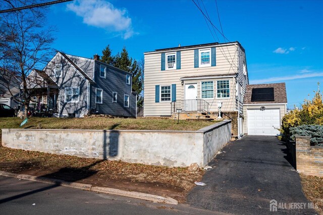 front of property featuring solar panels and a garage