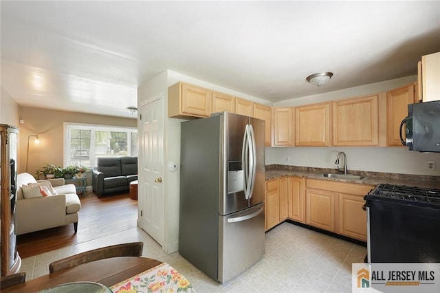 995 Old Bridge Tpke, East Brunswick, NJ 08816 - kitchen with stainless steel fridge, light brown cabinetry, range with gas cooktop, open floor plan, and black microwave