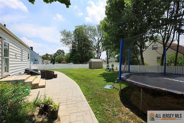 995 Old Bridge Tpke, East Brunswick, NJ 08816 - fenced backyard featuring a trampoline, a storage unit, and a patio area