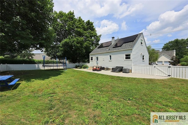 995 Old Bridge Tpke, East Brunswick, NJ 08816 - rear view of property with a gate, a patio area, a trampoline, and a fenced backyard