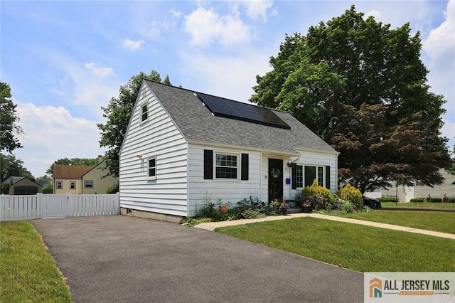 995 Old Bridge Tpke, East Brunswick, NJ 08816 - view of front of house with a shingled roof, solar panels, and asphalt driveway
