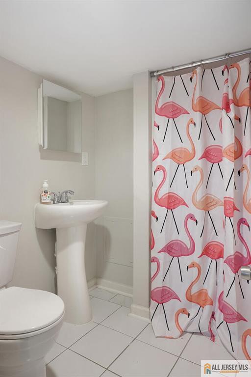 995 Old Bridge Tpke, East Brunswick, NJ 08816 - full bath with tile patterned flooring and a shower with curtain