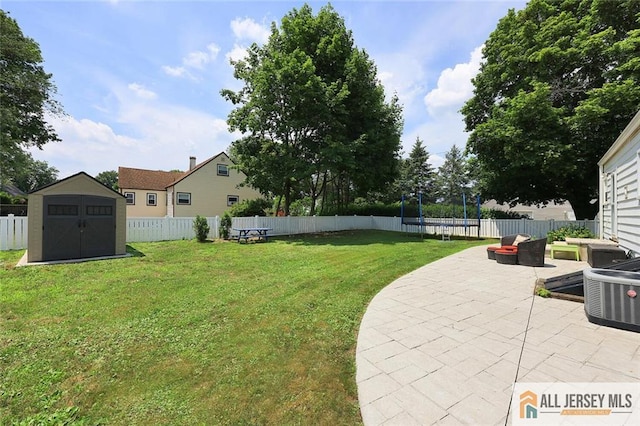 995 Old Bridge Tpke, East Brunswick, NJ 08816 - fenced backyard featuring a trampoline, a patio area, and a shed