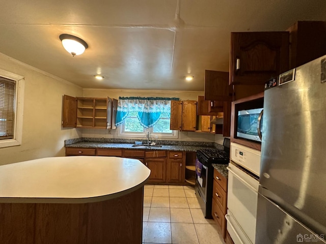 kitchen featuring sink, light tile patterned floors, and stainless steel appliances