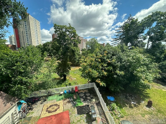 exterior space featuring a city view and fence