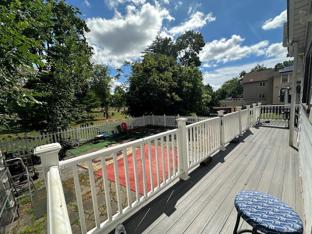 wooden deck with a fenced backyard