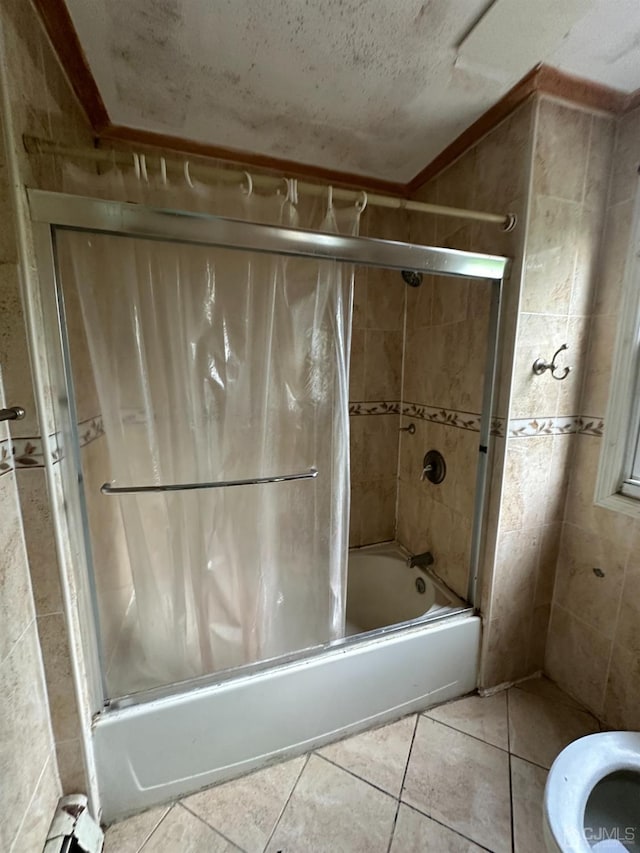 full bath with tile patterned flooring, a textured ceiling, and shower / bath combination with glass door