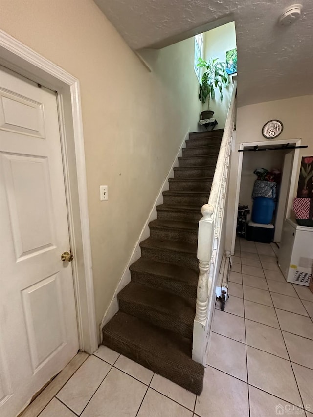 staircase with tile patterned floors