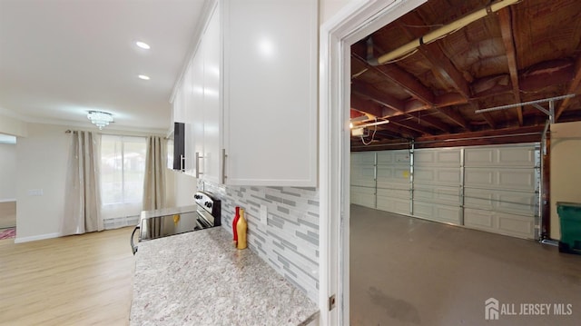 garage featuring recessed lighting and baseboards