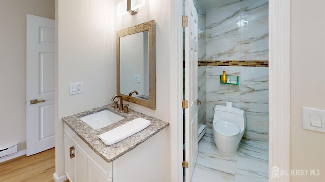 bathroom with vanity, a baseboard radiator, tile walls, toilet, and marble finish floor