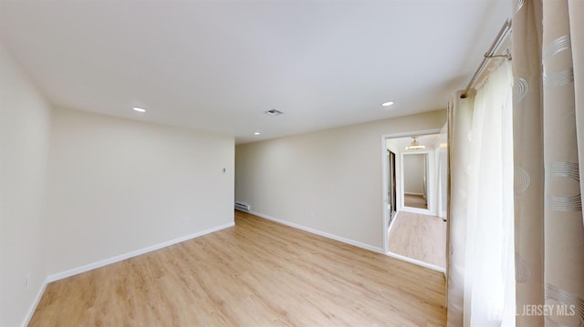 empty room featuring recessed lighting, visible vents, baseboards, and light wood-style floors