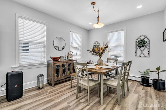 dining area featuring light wood-type flooring and a wealth of natural light