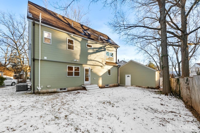 snow covered back of property with central AC unit