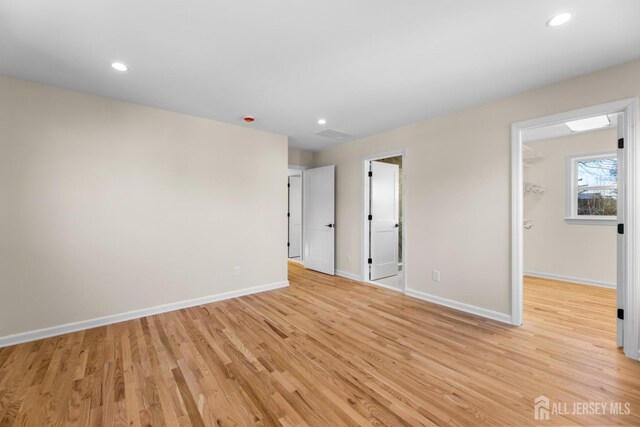 spare room with light hardwood / wood-style floors