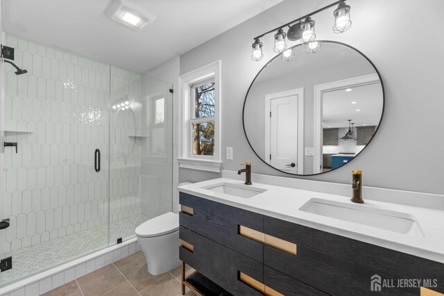 bathroom featuring tile patterned flooring, an enclosed shower, vanity, and toilet