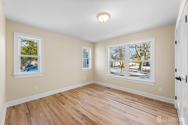 unfurnished room with light hardwood / wood-style flooring