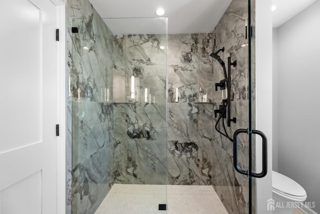 bathroom featuring toilet and an enclosed shower