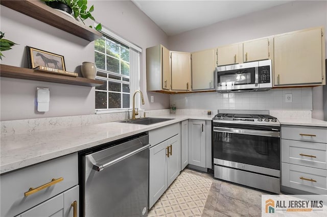 4301 Bayberry Ct, Middlesex, NJ 08852 - kitchen featuring appliances with stainless steel finishes, open shelves, gray cabinetry, and tasteful backsplash