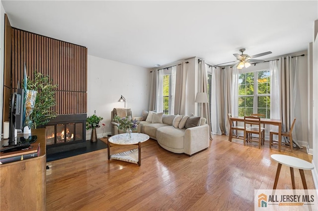 4301 Bayberry Ct, Middlesex, NJ 08852 - living area featuring healthy amount of natural light, light wood-style flooring, a ceiling fan, and a fireplace with flush hearth