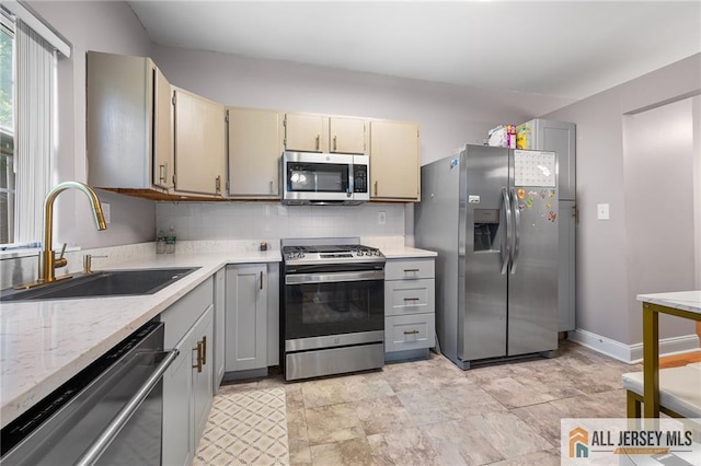 4301 Bayberry Ct, Middlesex, NJ 08852 - kitchen with appliances with stainless steel finishes, decorative backsplash, gray cabinets, and light stone countertops