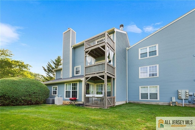 4301 Bayberry Ct, Middlesex, NJ 08852 - rear view of property with a balcony, a yard, and a chimney
