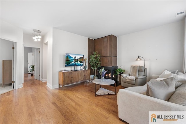 4301 Bayberry Ct, Middlesex, NJ 08852 - living room with light wood finished floors and a chandelier