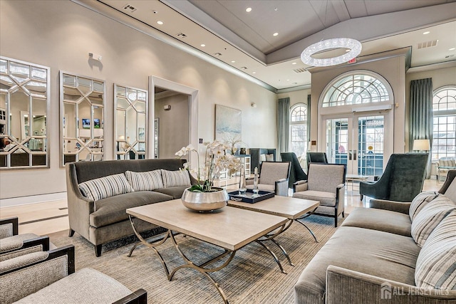 living room featuring high vaulted ceiling, recessed lighting, visible vents, and french doors