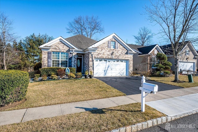 single story home with a garage, brick siding, driveway, roof with shingles, and a front lawn