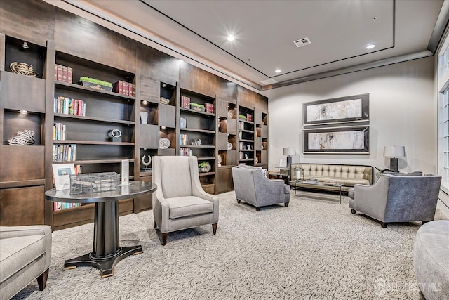 sitting room with recessed lighting, visible vents, crown molding, and carpet flooring