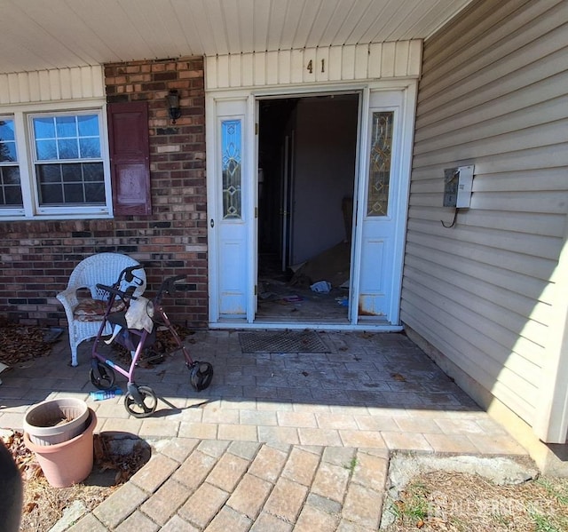 property entrance with brick siding