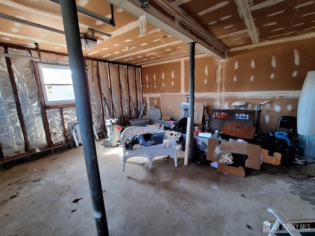 misc room with a garage and concrete flooring