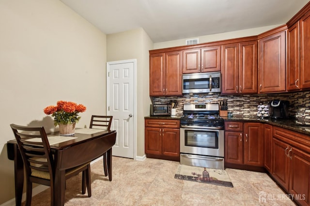 179 Sunshine Dr, Piscataway, NJ 08854 - kitchen with stainless steel appliances, backsplash, and dark stone countertops