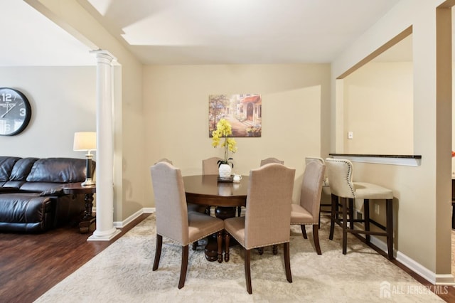 179 Sunshine Dr, Piscataway, NJ 08854 - dining area with decorative columns and wood finished floors