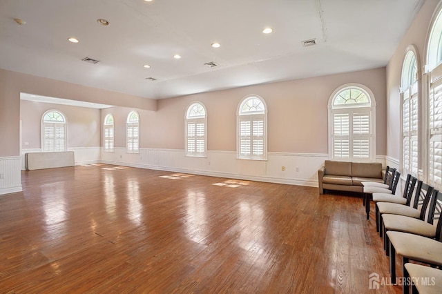 179 Sunshine Dr, Piscataway, NJ 08854 - unfurnished living room featuring a wainscoted wall, hardwood / wood-style floors, plenty of natural light, and recessed lighting