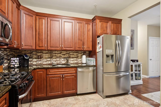 179 Sunshine Dr, Piscataway, NJ 08854 - kitchen with stainless steel appliances, tasteful backsplash, dark stone counters, and light wood-style flooring