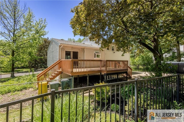 3 Revock Rd, East Brunswick, NJ 08816 - rear view of house with a wooden deck, stairway, and a fenced backyard