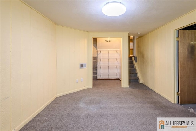 3 Revock Rd, East Brunswick, NJ 08816 - carpeted empty room with stairway, baseboards, and wood walls