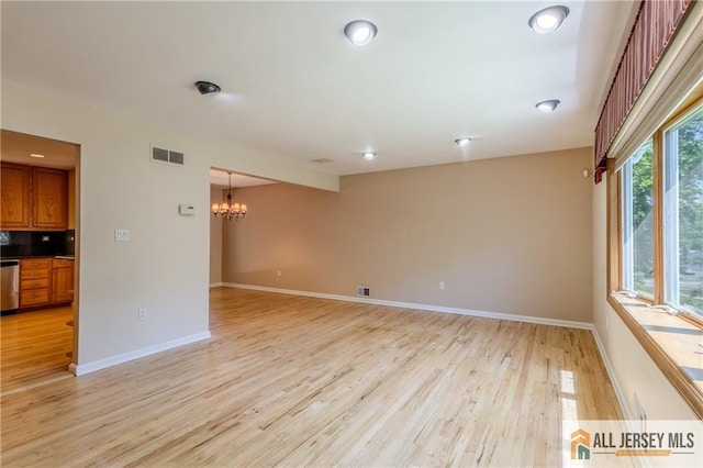3 Revock Rd, East Brunswick, NJ 08816 - spare room featuring a chandelier, light wood-style floors, and baseboards