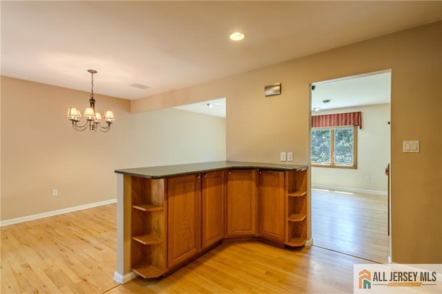 3 Revock Rd, East Brunswick, NJ 08816 - kitchen with open shelves, brown cabinets, light wood-style floors, a chandelier, and baseboards