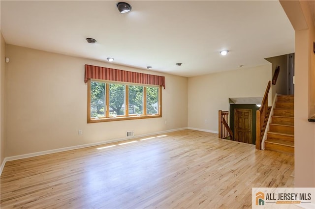 3 Revock Rd, East Brunswick, NJ 08816 - unfurnished living room featuring light wood-style floors, baseboards, and stairs