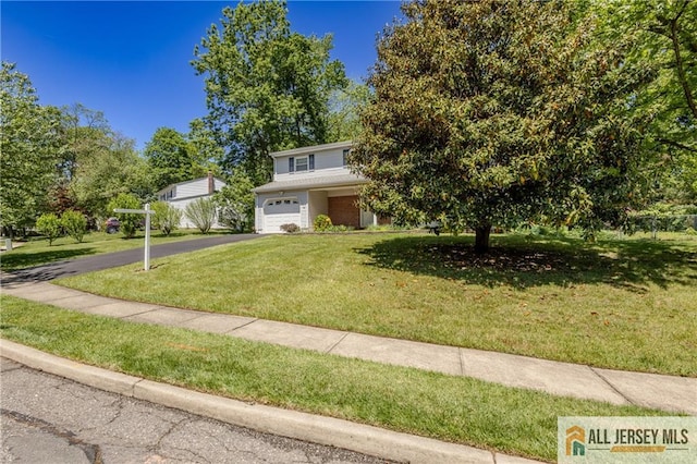 3 Revock Rd, East Brunswick, NJ 08816 - view of front of property featuring driveway, an attached garage, and a front yard